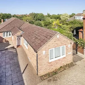 An aerial view of a house with a driveway.