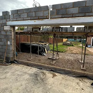 A building under construction with a brick wall.