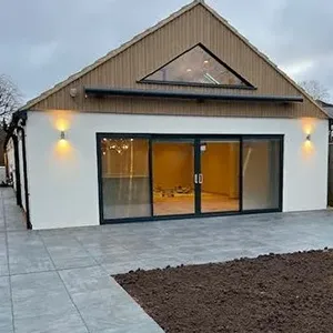 A white house with a black door and windows.