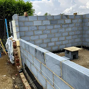 a construction site with a concrete block wall